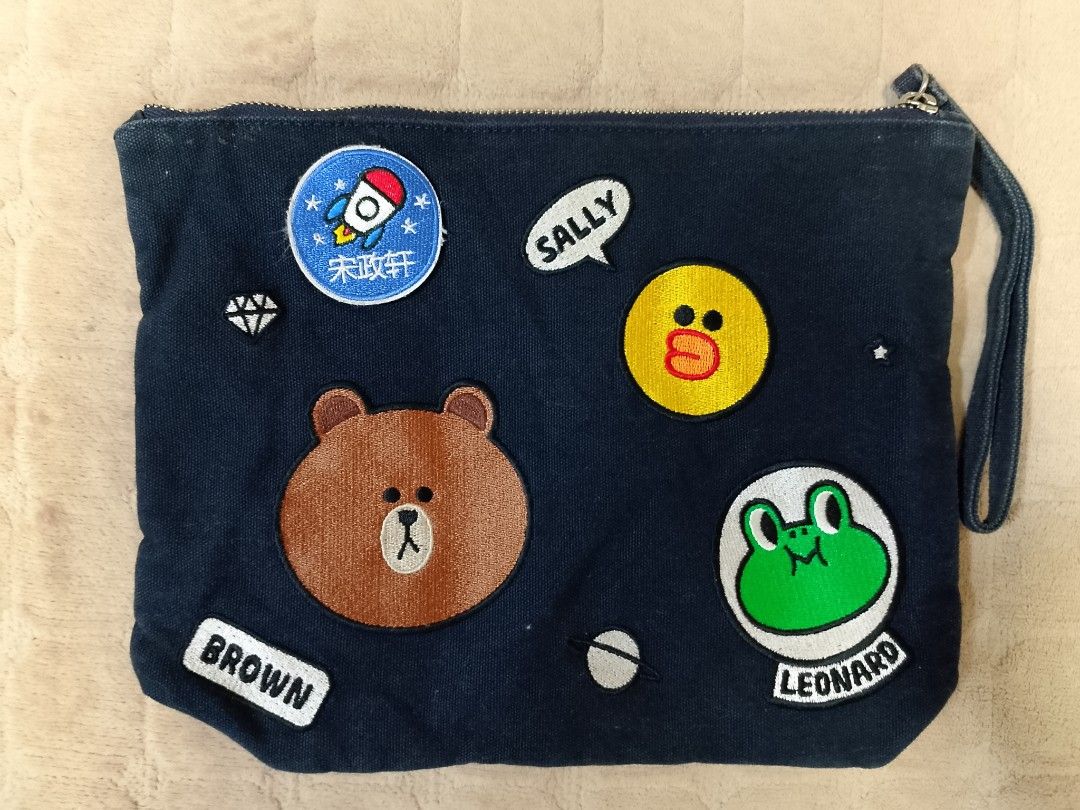 Line Friends " Friends Wappen Collection" (Category: Purses & Pouches) located in Caloocan City. Submitted by pvaliao (Listing ID 1462354797, Image 1). Description: A black fabric LINE FRIENDS character friends Wappen Clutch Bag Official Goods BLACK INDIGO decorated with embroidered character patches of Brown, Sally and Leonard. The item were part of the official 2016 -- 2017 Line Friends " Friends Wappen Collection. Fabric: Dark canvas Size: 11 