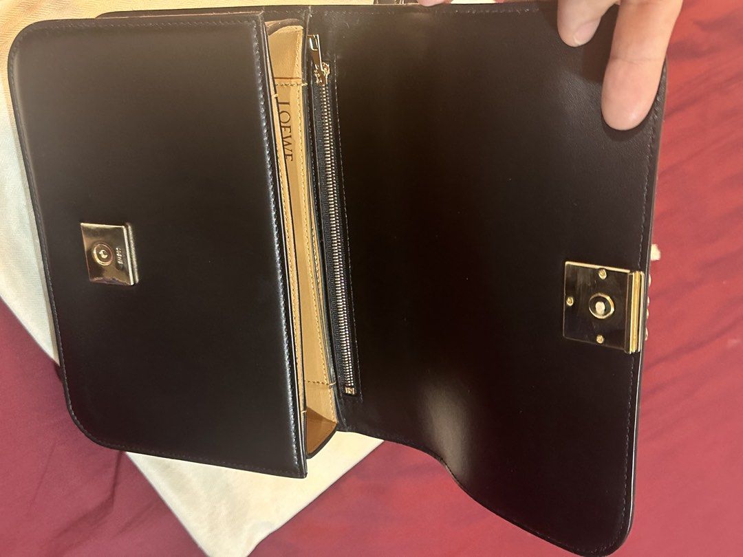 Loewe Black Leather Shoulder Bag with Gold Anagram (Category: Luxury Bags & Wallets) located in Mandaluyong City. Submitted by tonsaribay58244 (Listing ID 1462431237, Image 2). Description: - Loewe black leather shoulder bag - Iconic gold anagram clasp - Interior zip pocket and card slots - Made in Spain - Comes with dust bag - Perfect for daily use or special events.