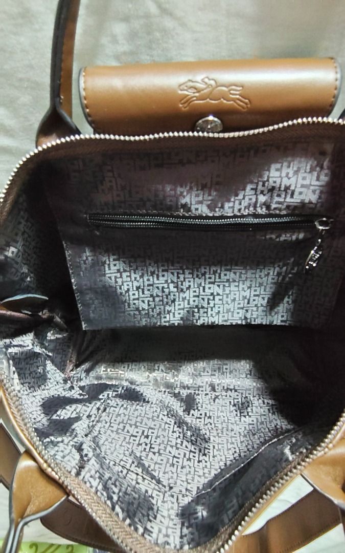 Longchamp Le Pliage Cuir Top Handle Bag (Category: Luxury Bags & Wallets) located in Caloocan City. Submitted by jpmshoppe (Listing ID 1462282617, Image 2). Description: - Authentic Longchamp handbag - Rich brown leather - Versatile: Top handles and detachable shoulder strap - Secure closure: Zipper with snap button flap - Crafted in France - Ideal everyday bag.