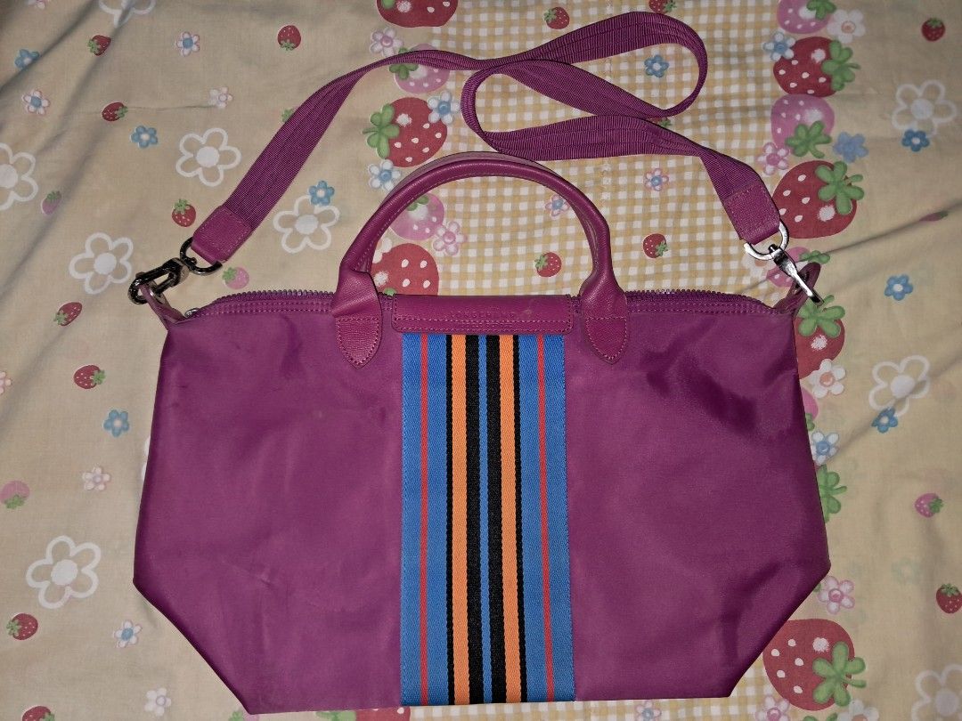 Longchamp Le Pliage Shoulder Bag Purple Striped (Category: Luxury Bags & Wallets) located in Manila. Submitted by terabentables2 (Listing ID 1462431141, Image 2). Description: LONGCHAMP SHOULDER BAG DETAILS ⋆｡𖦹°‧★ ── ₱300 ⋆ Purple Longchamp Le Pliage Bag ⋆ Eye-catching stripe detail on the front ⋆ Vibrant bright pink interior with a convenient small pocket ⋆ Secure zip-top closure ⋆ Ideal size for everyday school use ₊✩‧₊˚౨ৎ˚₊✩‧₊ MOP: GCASH MOD: