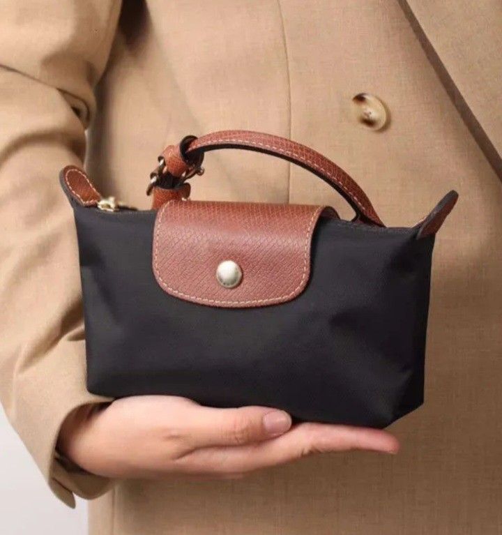 Longchamp Mini Pouch /Crossbody bag (Category: Purses & Pouches) located in Navotas City. Submitted by riyuwi (Listing ID 1462354717, Image 3). Description: PreOwned lightly Used Longchamp Pouch Mini hand/Crossbody bag - Elegant Brown Leather Trim & Handle - Detachable Shoulder Strap for Versatility - Secure Zipper Closure - Stylish Gold Hardware - Ideal for organizing essentials or as a standalone clutch XXS -Micro Sized Sign of Used sa detachab