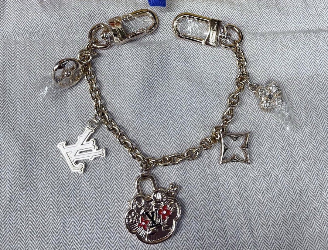 Louis Vuitton Bag Charm (Category: Charms) located in Angeles City. Submitted by migs_font29 (Listing ID 1462365457, Image 1). Description: - Authentic Louis Vuitton bag charm - Features iconic LV charms: lock with flowers, LV logo, flower shape - Includes a crystal-encrusted charm - Gold-tone chain and hardware - Secure lobster clasp closure - Ideal for personalizing your Louis Vuitton bag.