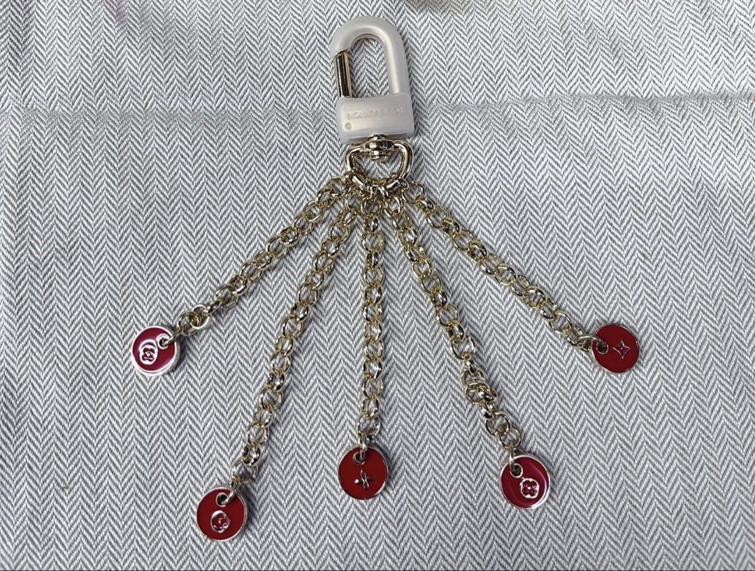 Louis Vuitton Bag Charm with Red Monogram Charms (Category: Community) located in Angeles City. Submitted by migs_font29 (Listing ID 1462365110, Image 1). Description: - Gold tone chain bag charm - Features multiple red circular charms with Louis Vuitton monograms - Attaches securely with a clear lock clasp - Ideal accessory to personalize your bag and add a pop of color.