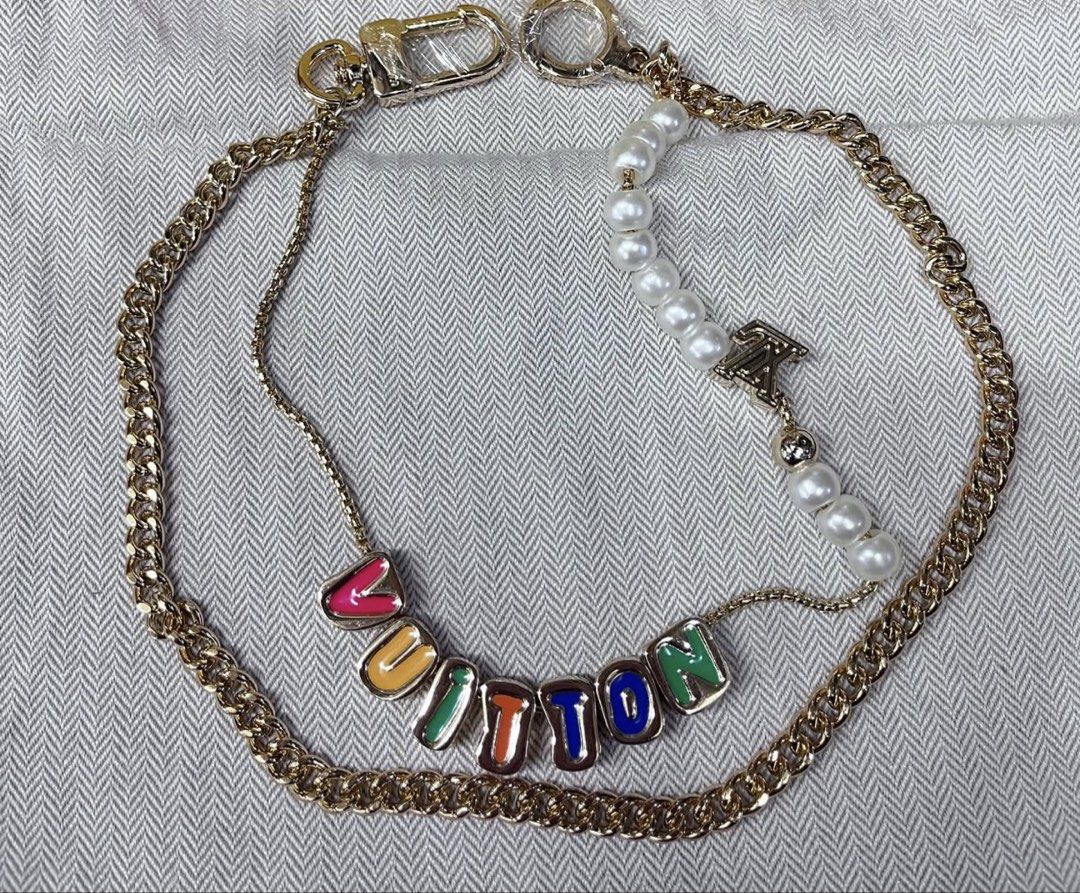 Louis Vuitton Multi-color Monogram Pearl Bag Charm (Category: Microphones) located in Angeles City. Submitted by migs_font29 (Listing ID 1462366096, Image 1). Description: - Gold chain necklace - Colorful 'LOUIS VUITTON' letter charms - Pearl strand with LV charm - Lobster clasp closure - Perfect statement piece.