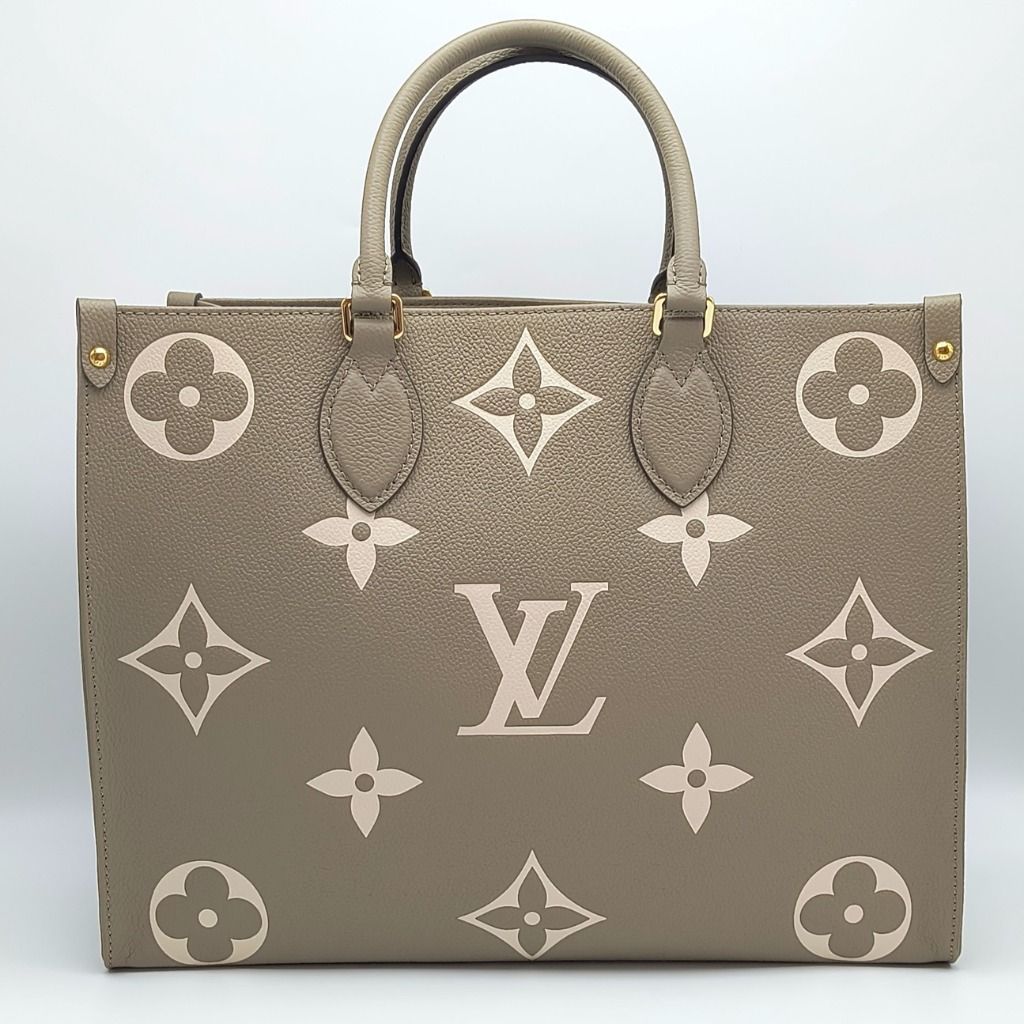 Louis Vuitton OnTheGo MM Bag - Bicolor Tourterelle Creme (Category: Luxury Bags & Wallets) located in Cebu City. Submitted by theluxxaffair (Listing ID 1462433925, Image 1). Description: Louis Vuitton OnTheGo MM Bicolor tote bag in Tourterelle Crème embossed Empreinte leather. Features the oversized Monogram pattern, gold-tone hardware, dual top handles and long shoulder straps. Spacious interior with zip and slip pockets. Length: 33 cm Height: 2