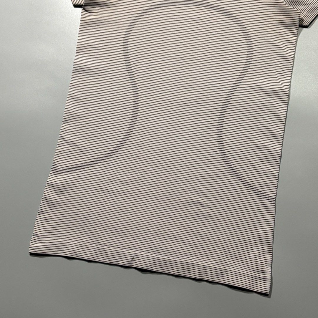Lululemon Striped Swiftly Tech Short Sleeve (Category: Activewear) located in Tayabas. Submitted by tayabaskartell (Listing ID 1462435979, Image 3). Description: Lululemon Striped Swiftly Tech Short Sleeve Seamless anti-stink knit with woven hem text and size indicator. Classic runner top. Lululemon Athletica introduced the Swiftly Tech line as a benchmark in high-performance running and training apparel, utilizing seamless body-mapped constructi