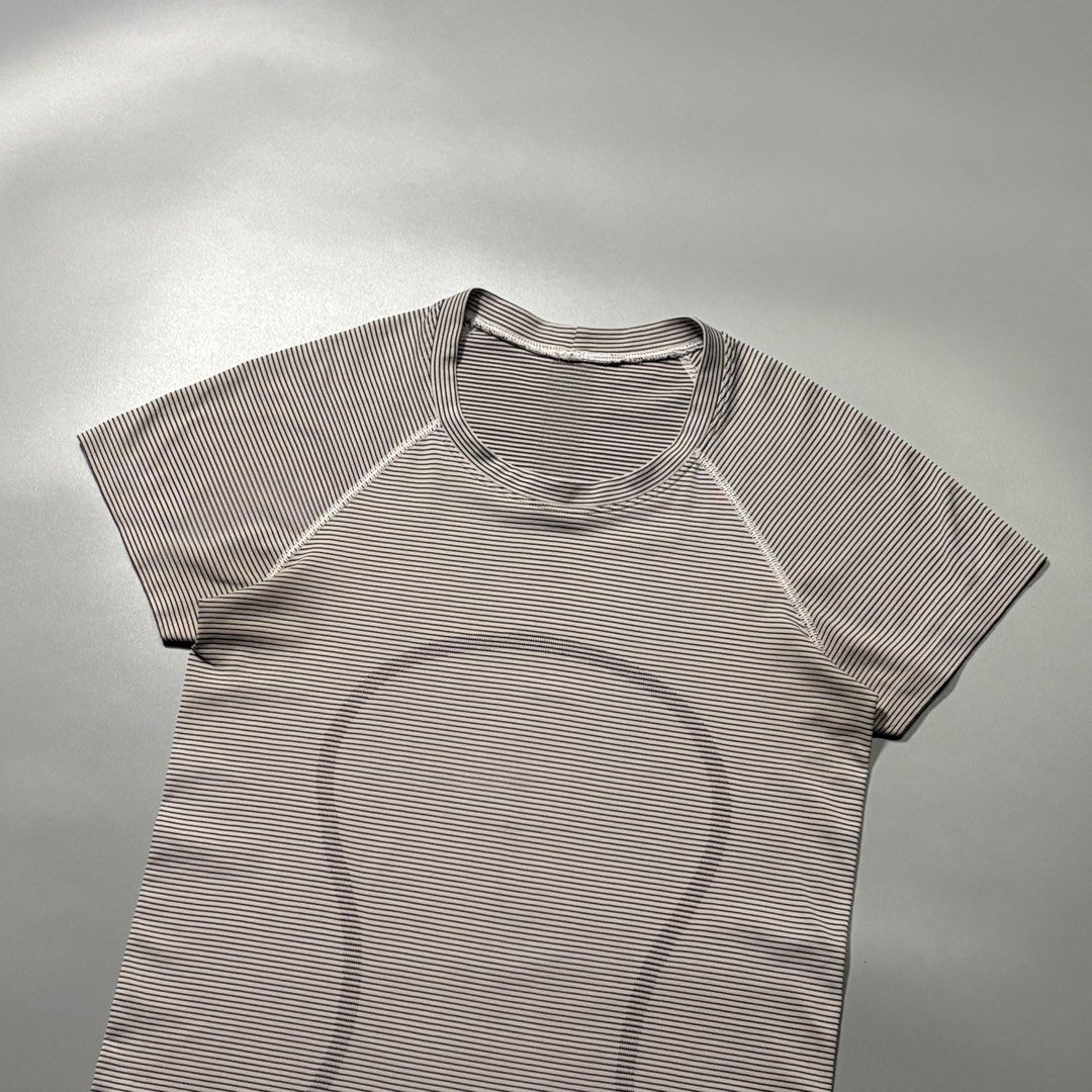 Lululemon Striped Swiftly Tech Short Sleeve (Category: Activewear) located in Tayabas. Submitted by tayabaskartell (Listing ID 1462435979, Image 2). Description: Lululemon Striped Swiftly Tech Short Sleeve Seamless anti-stink knit with woven hem text and size indicator. Classic runner top. Lululemon Athletica introduced the Swiftly Tech line as a benchmark in high-performance running and training apparel, utilizing seamless body-mapped constructi
