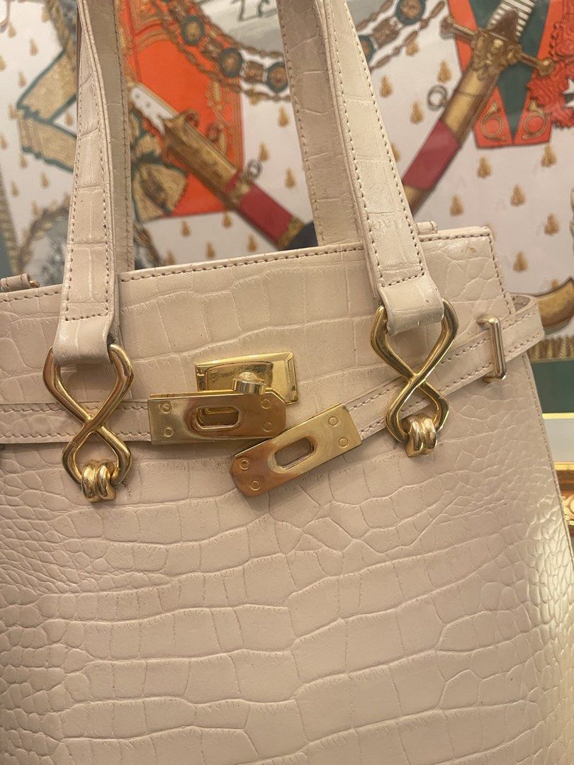 Luna Borza Crocodile Embossed Handbag (Category: Luxury Bags & Wallets) located in Marilao. Submitted by wardrovearchives (Listing ID 1462275047, Image 3). Description: - Cream colored handbag - Crocodile embossed texture - Gold hardware details (clasp & straps) - Interior zippered pocket - Brand: Luna Borza - Versatile for everyday or special occasions.