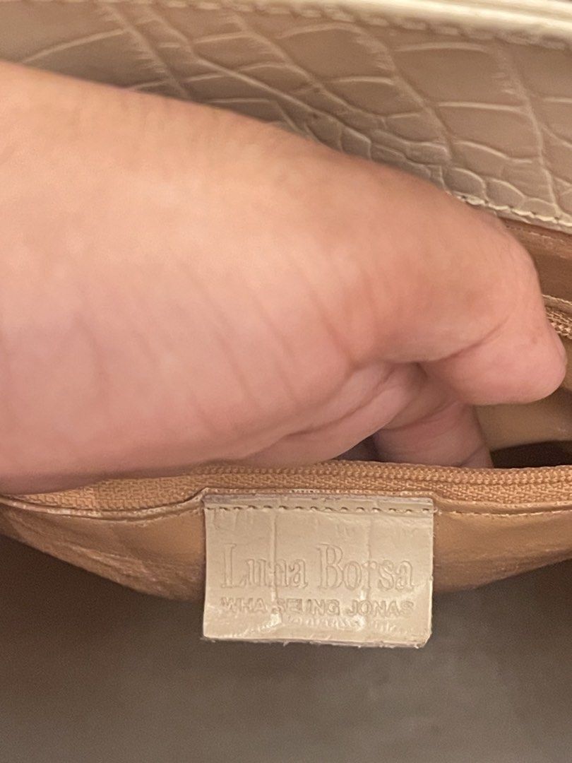 Luna Borza Crocodile Embossed Handbag (Category: Luxury Bags & Wallets) located in Marilao. Submitted by wardrovearchives (Listing ID 1462275047, Image 2). Description: - Cream colored handbag - Crocodile embossed texture - Gold hardware details (clasp & straps) - Interior zippered pocket - Brand: Luna Borza - Versatile for everyday or special occasions.