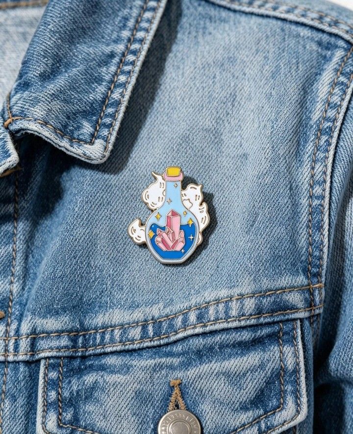 Magical Crystal Potion Bottle Enamel Pin ✨🔮 (Category: Babies & Kids Fashion) located in Quezon City. Submitted by wjmae (Listing ID 1462287702, Image 3). Description: Style: Fantasy / witchy aesthetic — potion bottle with spirit cats & crystals Material: Hard enamel finish with polished gold-toned metal Size: 2.9 cm tall × 2.4 cm wide (≈ 1.14" × 0.94") Fastening: Gold-coloured clutch backing — secure & easy to wear 🔮 Design Details: - Shimmery
