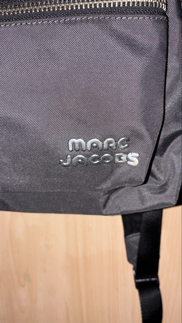 Marc Jacobs Black Nylon Backpack (Category: Backpacks) located in Placer. Submitted by talaalond61563 (Listing ID 1462277169, Image 2). Description: - Classic gray Marc Jacobs backpack - Durable nylon material - Front zip pocket and main compartment - Silver-tone hardware with subtle branding - Adjustable shoulder straps for comfort - Ideal for everyday use or travel.
