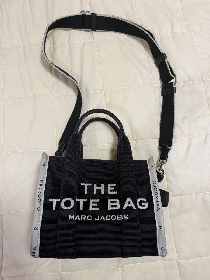 Marc Jacobs The Tote Bag Black Canvas (Category: Luxury Bags & Wallets) located in Paranaque City. Submitted by kimgcham (Listing ID 1462378888, Image 1). Description: - Authentic Marc Jacobs "The Tote Bag" - Durable black canvas material - Versatile crossbody option with included long strap - Immaculate and clean interior - Ideal for everyday essentials and errands.