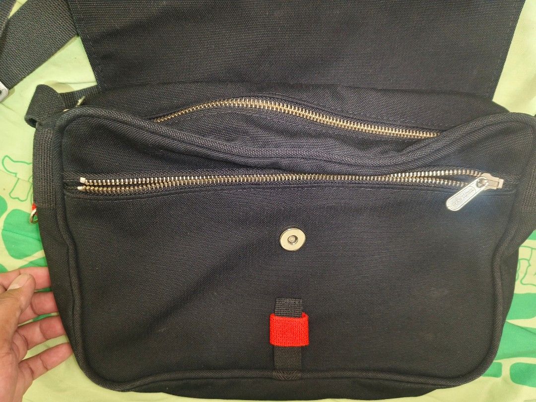 Marimekko sling Bag (Category: Luxury Bags & Wallets) located in Sariaya. Submitted by queen_1213 (Listing ID 1462263765, Image 2). Description: - Stylish black messenger bag - Main compartment with 2 internal zippered pockets - Secure magnetic snap closure on flap - High-quality, durable YKK zippers - Adjustable strap for comfortable wear - Simple and functional design.