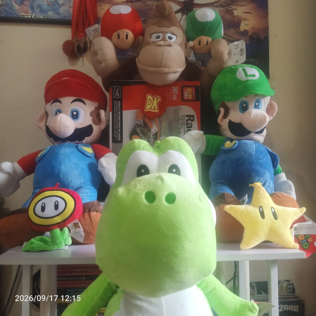 Mario and luigi etc. Plushie (Category: Plushies & Soft Toys) located in Manila. Submitted by yaaaaaj- (Listing ID 1462313582, Image 1). Description: Mario: Large plush wearing his classic red hat and blue overalls. Luigi: Large plush wearing a green hat and matching blue overalls. Yoshi: Large green and white dinosaur plush sitting at the front. Donkey Kong: Brown plush positioned on the upper shelf. Diddy Kong: Smaller brown plush with a red ca