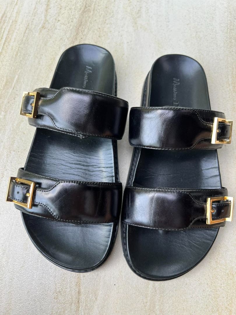 Massimo Dutti Black Leather Double Strap Slides Gold Buckle (Category: Flats & Sandals) located in Muntinlupa City. Submitted by execoffic56216 (Listing ID 1462323789, Image 1). Description: - Brand: Massimo Dutti - Color: Black - Material: Leather - Style: Slides with two wide straps - Details: Gold buckle accents - Closure: Slip-on - Condition: Good, with minor signs of wear on leather.