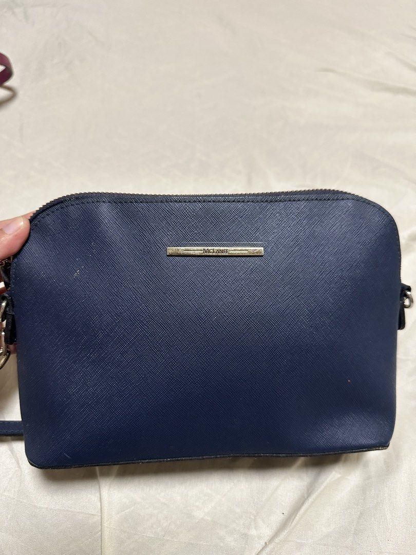 MCLANE Navy Blue Crossbody Bag (Category: Cross-body Bags) located in Cotabato. Submitted by pawpaw1027 (Listing ID 1462363142, Image 1). Description: - Navy blue MCLANE crossbody bag - Genuine Saffiano leather texture - Secure zip closure - Small metal logo plate detail - Adjustable strap for comfortable wear - Ideal for everyday use.