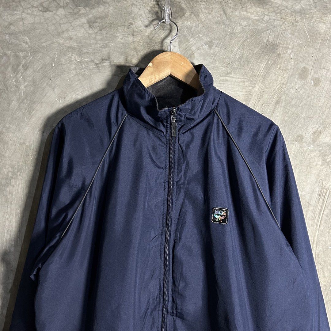MCM - Nylon Jacket (Category: Luxury Apparel) located in Tayabas. Submitted by streetdepartment (Listing ID 1462266987, Image 2). Description: MCM - Nylon Jacket Measurements (inches): Width: 24” Length: 29.5” Tagged as LL fits Large - XL Very good condition Flaw/s: Missing string on hem and not so visible stain (kindly check pics for reference).