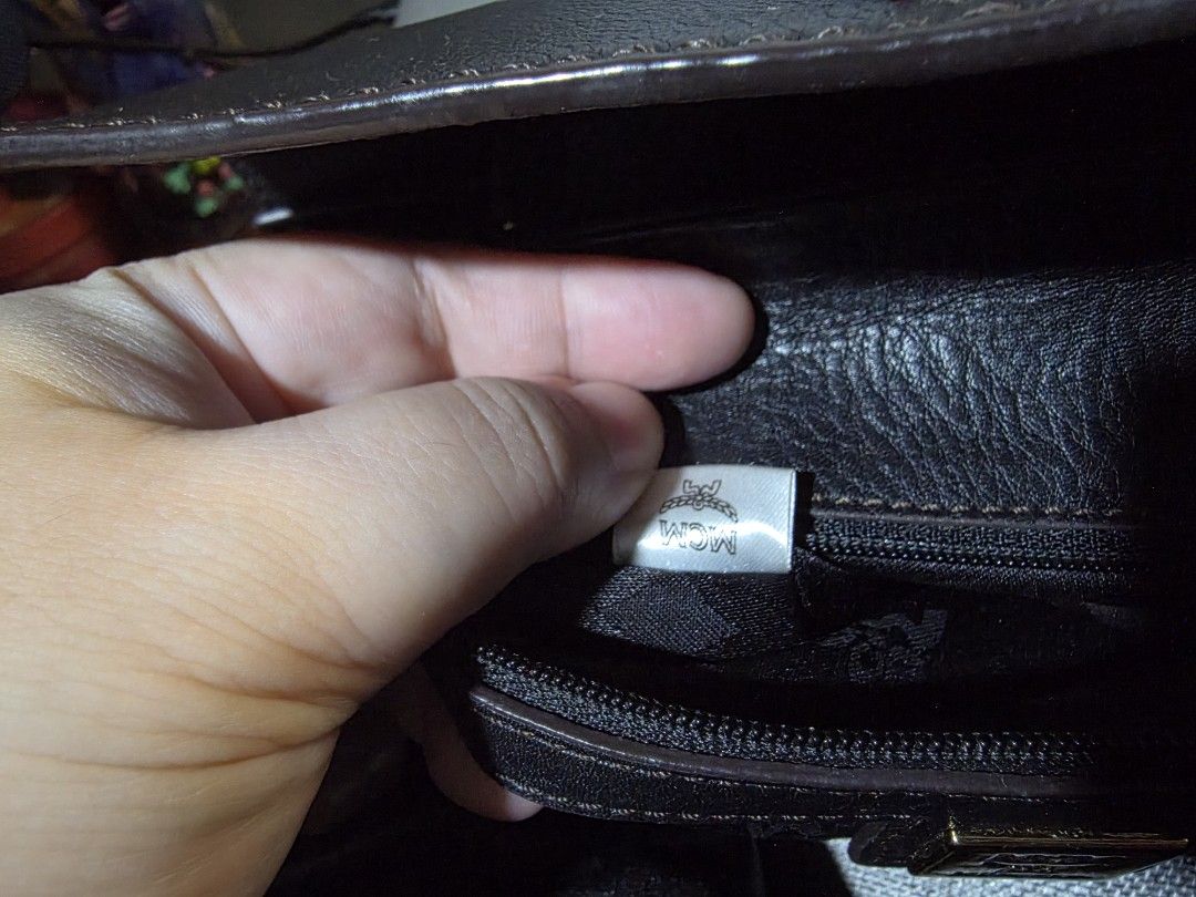 MCM Black Leather Top Handle Bag (Category: Luxury Bags & Wallets) located in Mandaluyong City. Submitted by artlin04 (Listing ID 1462307012, Image 3). Description: - Authentic MCM handbag in classic black leather. - Elegant gold-tone hardware, including the signature MCM logo clasp. - Spacious interior with MCM logo lining and a convenient zippered pocket. - Features sturdy top handles for comfortable carrying. - Secure flap closure to keep your