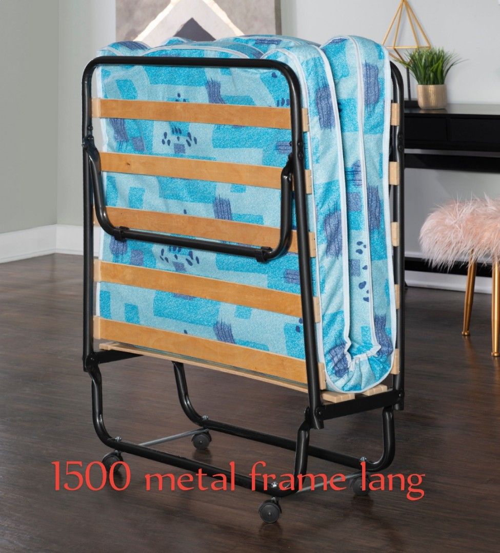 Metal Frame Folding Bed with Blue Mattress (Category: Bed Frames & Mattresses) located in Caloocan City. Submitted by samyx23 (Listing ID 1462354215, Image 1). Description: - Sturdy metal frame folding bed - Includes comfortable blue patterned mattress - Folds easily for convenient storage - Equipped with wheels for easy mobility - Ideal for guest rooms or extra sleeping space.
