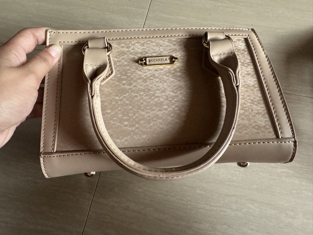 MICHAELA Beige Textured Top Handle Bag with Strap (Category: Cross-body Bags) located in Valenzuela. Submitted by tricegonzales (Listing ID 1462335999, Image 1). Description: - Brand: MICHAELA - Color: Beige - Material: Textured - Features: Top handles, detachable shoulder strap, zipper closure - Hardware: Gold details - Interior: Spacious, fits essentials - Ideal for: Everyday use.