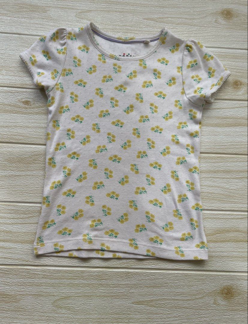 Mini Boden t-shirt (Category: Babies & Kids Fashion) located in Cebu City. Submitted by yjainani (Listing ID 1462344792, Image 1). Description: cream short-sleeve girls' t-shirt from Mini Boden featuring a delicate yellow floral pattern and a textured pointelle knit.