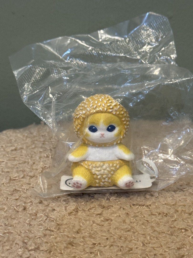 Mofusand Sesami Figure (Category: Designer & Blind Box Toys) located in Cainta. Submitted by mica.sa (Listing ID 1462378474, Image 1). Description: - Adorable yellow cat figurine - Textured yellow outfit and matching hat - Blue eyes and pink paw pads - Comes in original plastic packaging - Ideal for collectors or as a desk decoration.