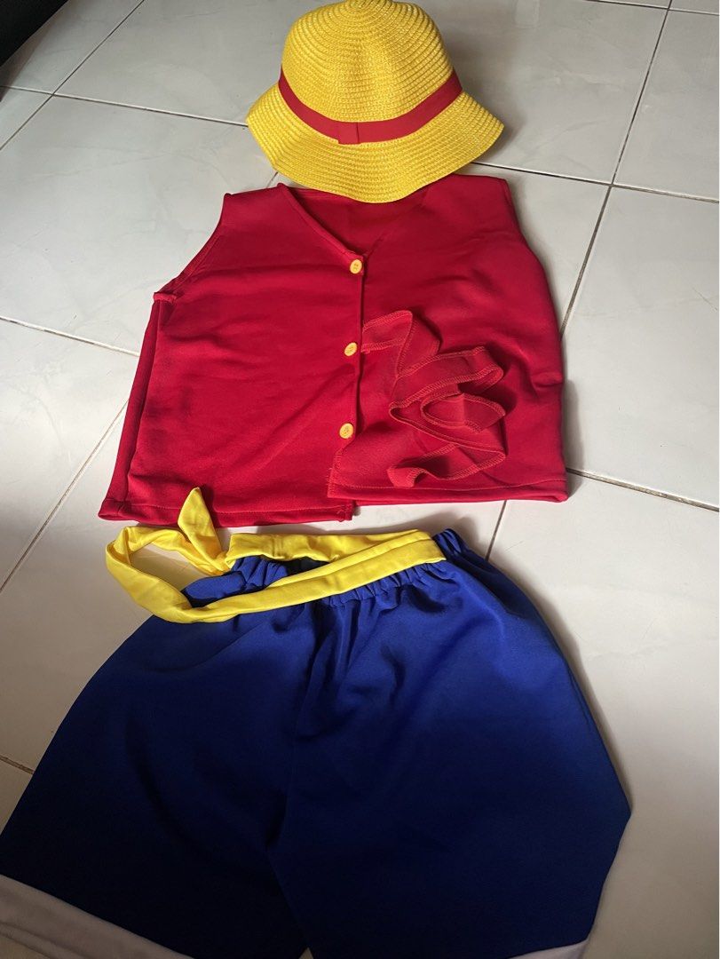 Monkey D. Luffy Costume Set with Hat (Category: Babies & Kids Fashion) located in Tabaco. Submitted by devskie (Listing ID 1462281204, Image 1). Description: - Complete Monkey D. Luffy costume set - Iconic red vest with yellow buttons and ruffled detail - Blue shorts with yellow waistband - Straw hat with red ribbon included - Ideal for cosplay, costume parties, or dress-up events - Once used only for Pictorial - Ready for its new owner!.