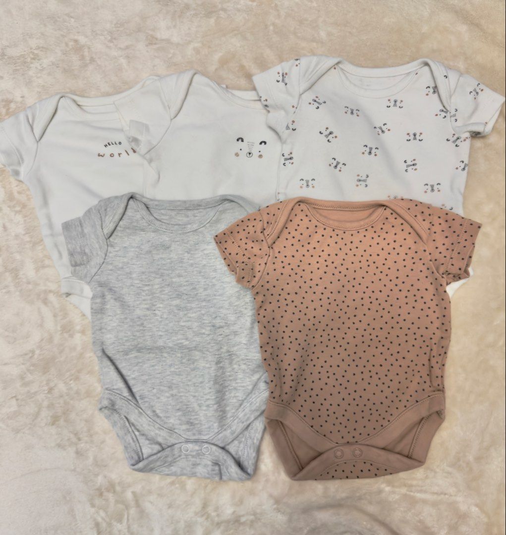 Mothercare Bodysuits and Bibs Bundle - Various Designs (Category: Babies & Kids Fashion) located in Pasig City. Submitted by erikagill1697-91390 (Listing ID 1462420039, Image 1). Description: - Bundle includes baby bodysuits and bibs. - Bodysuits: Short-sleeved in white, grey, pink with prints (pandas, hearts). - Bodysuits: White with animal prints and yellow polka dots. - Bibs: Light blue and beige with animal designs. - Mothercare 0-3months.