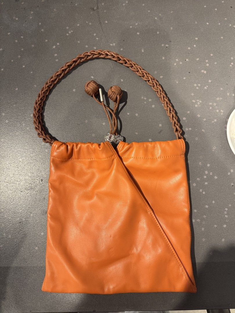 Muunsan Orange Leather Drawstring Handbag with Braided Strap (Category: Shoulder Bags) located in Manila. Submitted by declutterkween14 (Listing ID 1462340028, Image 3). Description: .