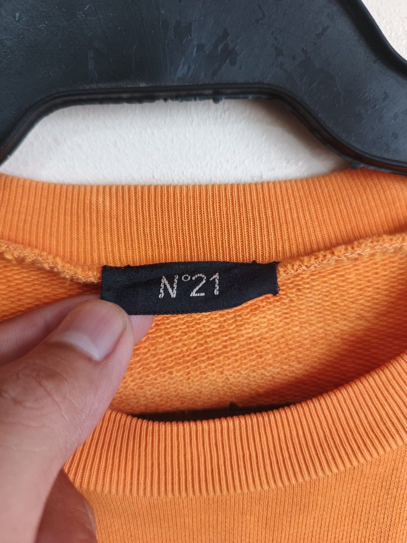 N°21 Orange Cotton Sweatshirt (Category: Longsleeves) located in Dasmarinas. Submitted by jessicamae43174 (Listing ID 1462278350, Image 3). Description: - Brand: N°21 - Color: Orange - Style: Crewneck Sweatshirt - Material: 100% Cotton - Origin: Made in Turkey - Features: Blue gel-like logo patch on front, ribbed cuffs and hem - Occasion: Casual wear.