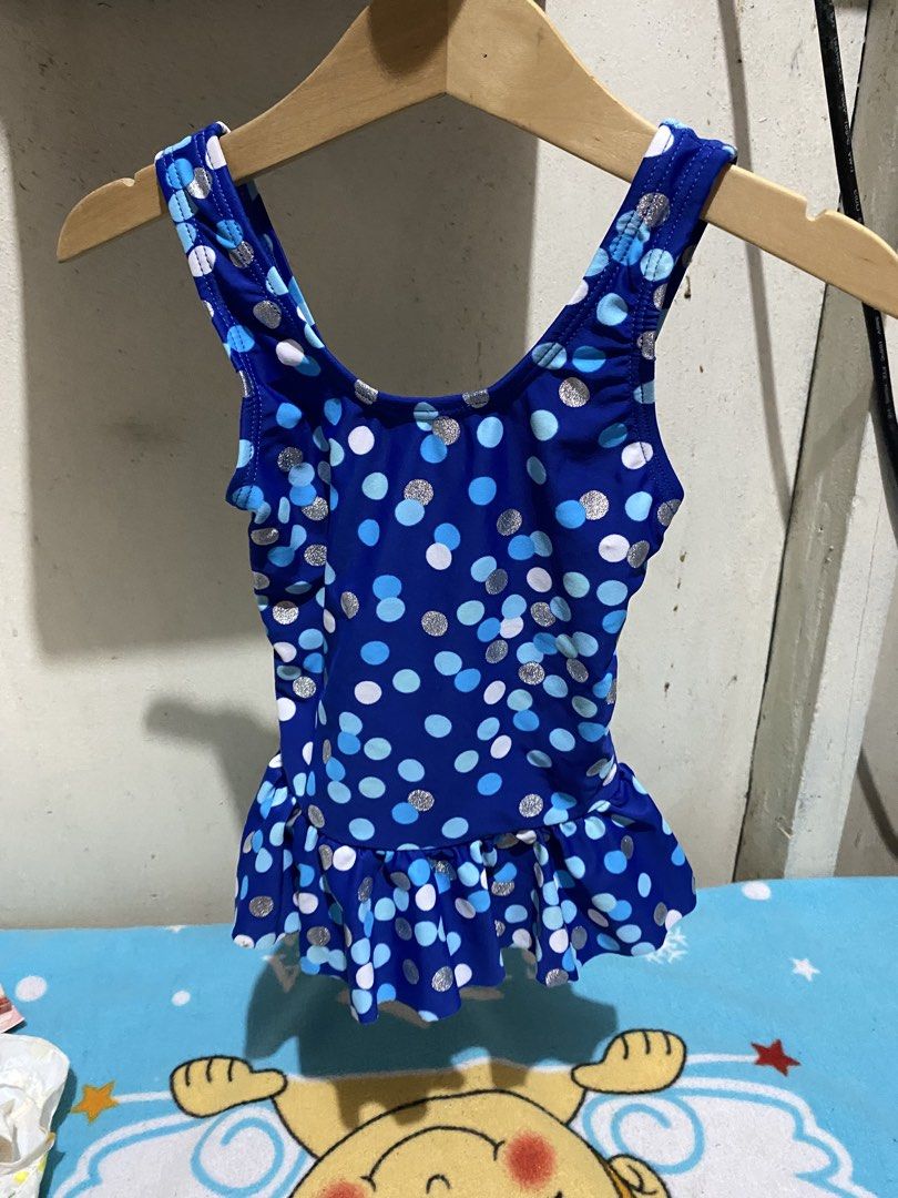 Nassau Blue Polka Dot Ruffle Swimsuit (Category: Babies & Kids Fashion) located in Manila. Submitted by resi.diaz (Listing ID 1462321532, Image 1). Description: - Adorable blue swimsuit with charming polka dot pattern. - Features a cute ruffle hem for extra flair. - Ideal for swimming lessons, beach trips, or any water play. - Comfortable straps and secure fit for active kids. - Brand: Nassau - Size: 45- chest circumference 50- hip circumference 