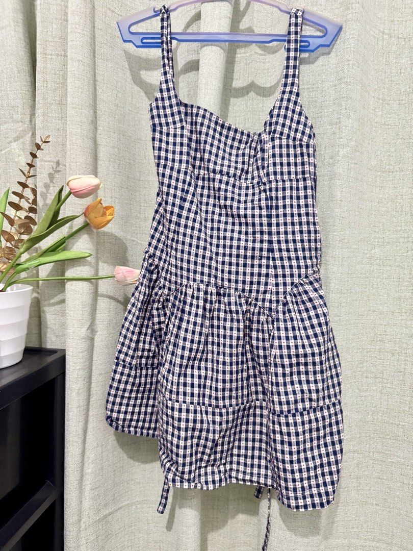 Navy and White Gingham Tiered Mini Dress (Category: Dresses) located in Calasiao. Submitted by crzzrlc (Listing ID 1462345641, Image 1). Description: - Navy and white gingham mini dress - Tiered skirt for a playful look - Adjustable tie straps for a perfect fit - Flattering sweetheart neckline with ruched detailing - Ideal for casual days, picnics, or beach trips - Easily pairs with sandals or sneakers.