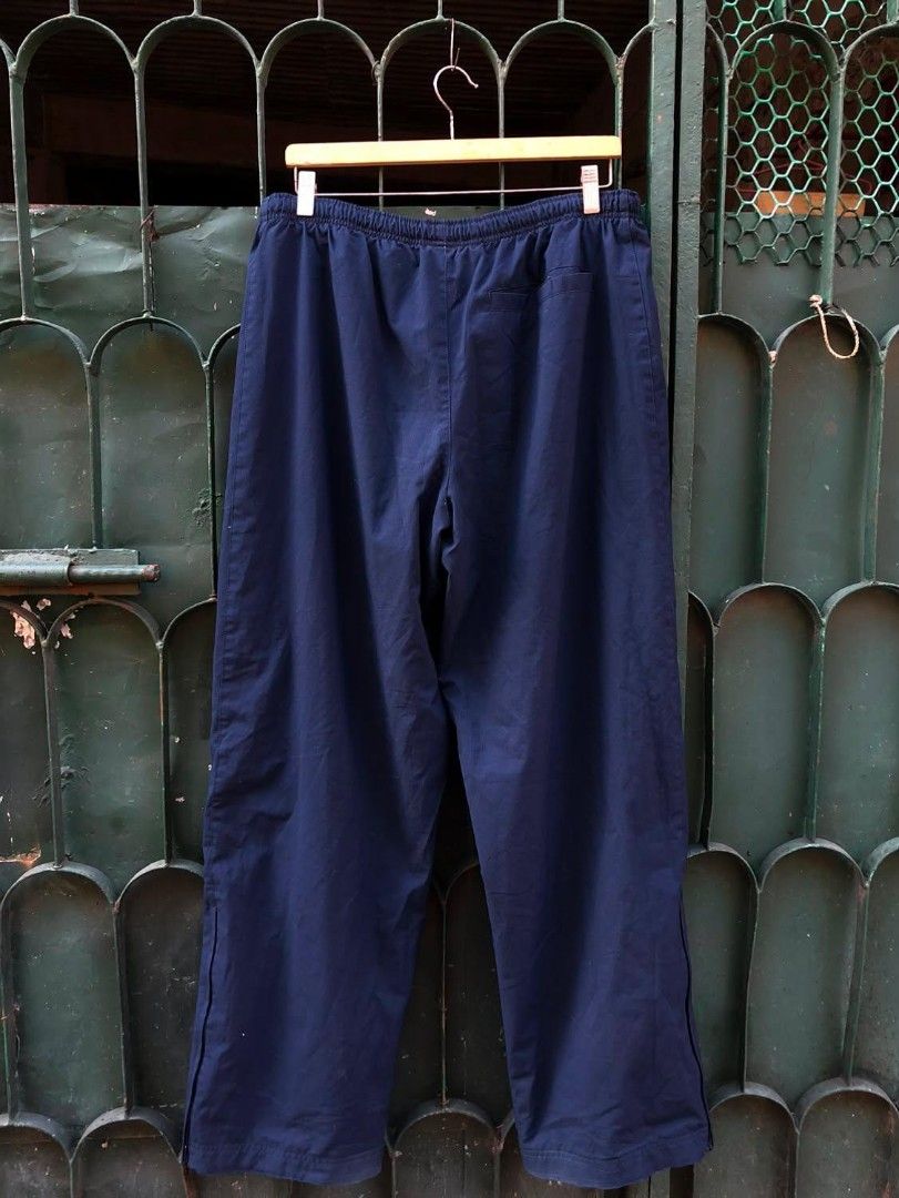 Navy Blue Nike Track Pants 34/38(41) (Category: Joggers) located in Manila. Submitted by kuyanyo (Listing ID 1462352266, Image 2). Description: - Classic navy blue Nike track pants - Elastic waistband with drawstring for adjustable fit - Convenient side pockets - Subtle Nike swoosh logo on the left leg - Ideal for casual outings or athletic activities - Offers a comfortable and relaxed fit.