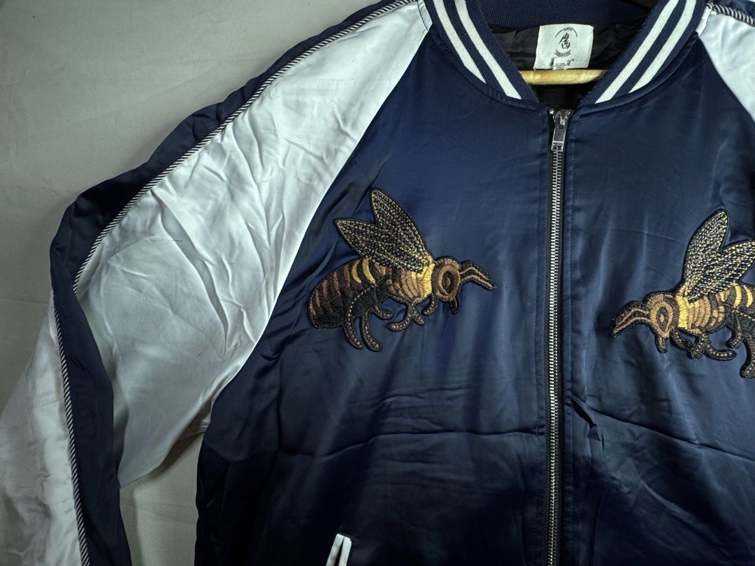 Navy Bomber Jacket with Bee and Snake Embroidery (Category: Coats, Jackets and Outerwear) located in Roxas City. Submitted by patsquarephantz (Listing ID 1462325171, Image 3). Description: - Cool navy bomber jacket - Embroidered bees on front - Snake with text graphic on back - White sleeves - Blue and white striped cuffs and collar - Zipper closure - Perfect statement piece.
