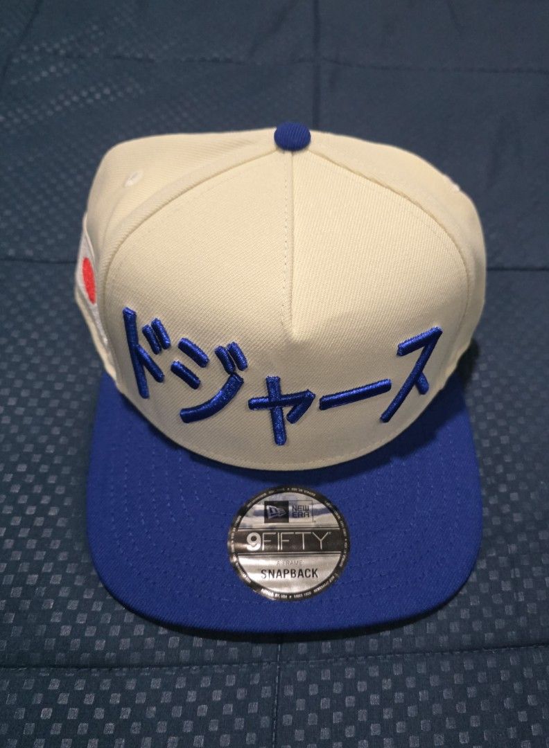 New Era 9FIFTY Snapback Dodgers Japanese Cap (Category: Caps & Hats) located in Santa Rosa. Submitted by rowhell09 (Listing ID 1462388844, Image 1). Description: Dodgers Kanji Two Tone Brand new 2300 MOD. LBC MOP. BDO, GCASH LOC. NUEVA ECIJA - Brand: New Era - Style: 9FIFTY Snapback - Color: Cream and Royal Blue - Features: Japanese text embroidery on front, Japan flag patch on side - Ideal for: Dodgers fans, streetwear enthusiasts.