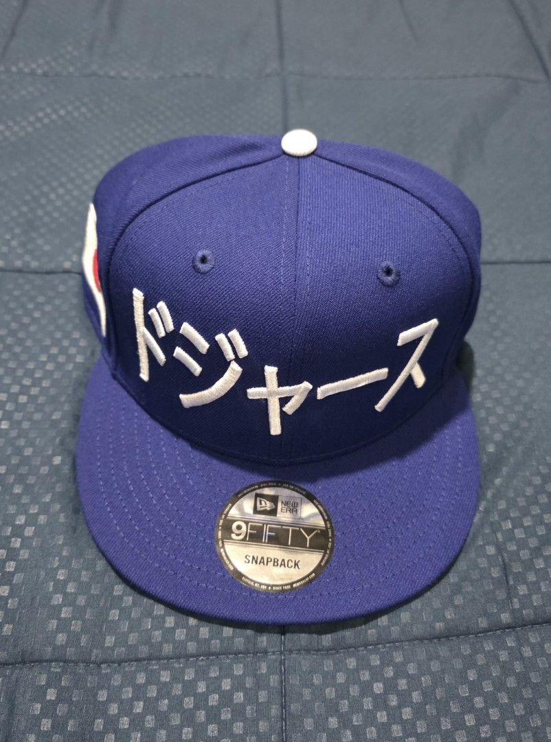 New Era 9FIFTY Snapback Hat - Blue with Japanese Text (Category: Caps & Hats) located in Santa Rosa. Submitted by rowhell09 (Listing ID 1462389237, Image 1). Description: Dodgers Kanji Blue Brandnew 2300 MOD. LBC MOP. BDO, GCASH LOC. NUEVA ECIJA - Brand: New Era - Style: 9FIFTY Snapback - Color: Blue - Features: Japanese text on front, Japanese flag on side - Closure: Adjustable snapback - Perfect for hat collectors.