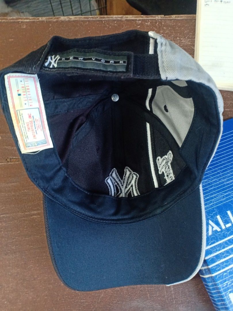 New York Yankees Baseball Cap (Category: Caps & Hats) located in Santa Rosa. Submitted by abj_104 (Listing ID 1462295912, Image 3). Description: - Classic New York Yankees cap - Black with grey brim and accents - Iconic embroidered 'NY' ogo on the front - Adjustable strap at the back for a customized fit - Ideal for any dedicated Yankees fan.