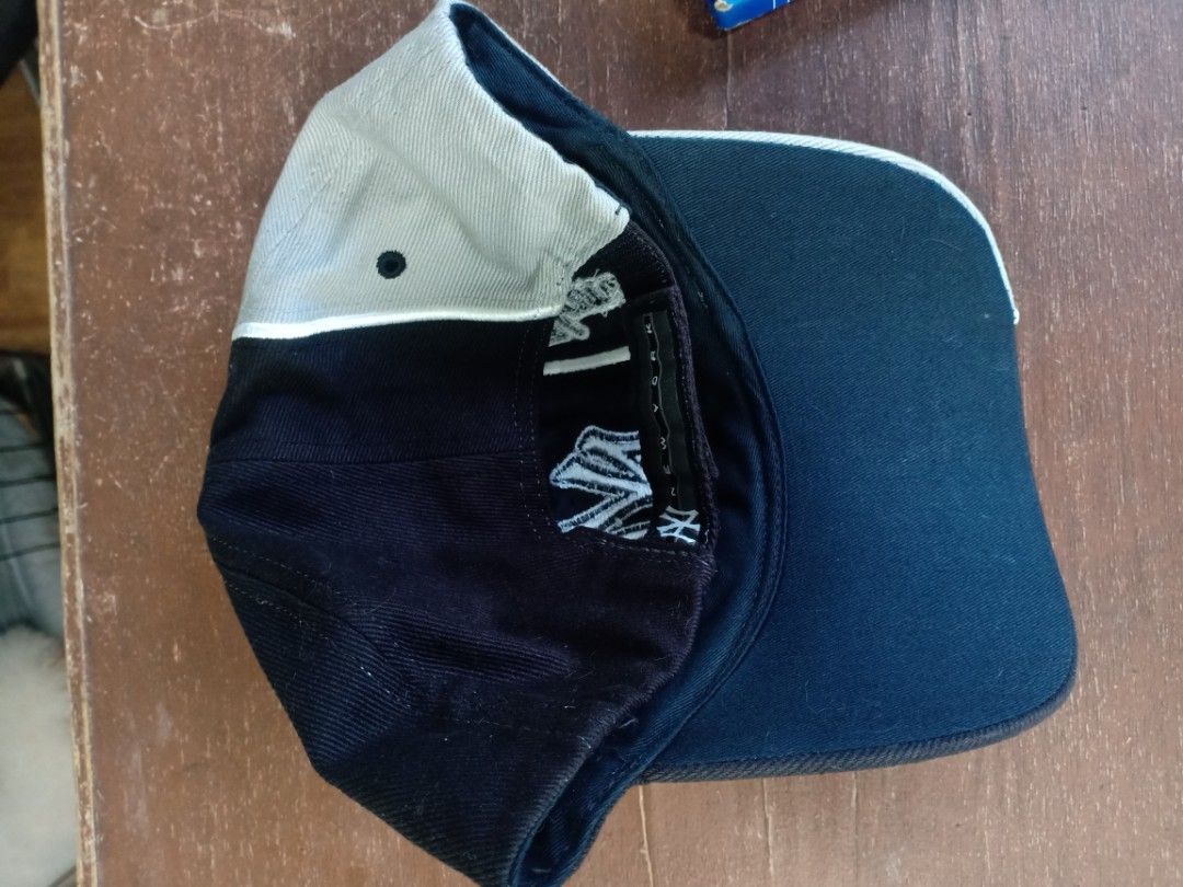 New York Yankees Baseball Cap (Category: Caps & Hats) located in Santa Rosa. Submitted by abj_104 (Listing ID 1462295912, Image 2). Description: - Classic New York Yankees cap - Black with grey brim and accents - Iconic embroidered 'NY' ogo on the front - Adjustable strap at the back for a customized fit - Ideal for any dedicated Yankees fan.