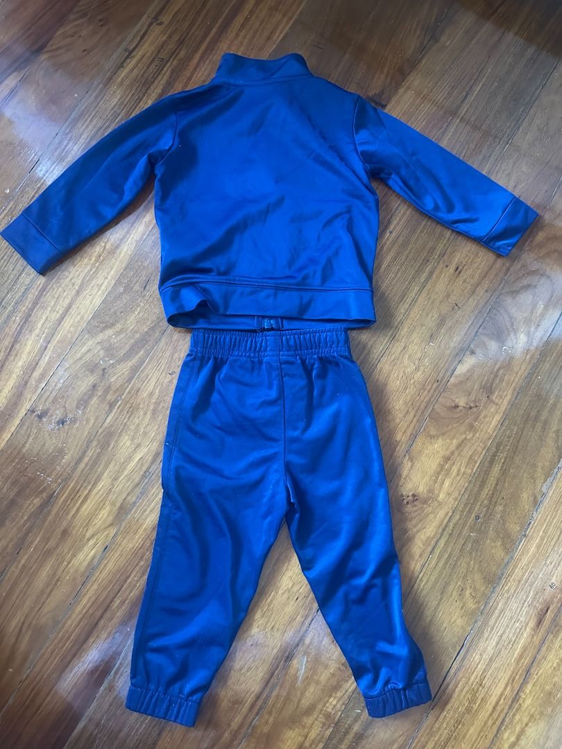 Nike Blue Jacket & Pants Tracksuit Set, Size: 18M (Category: Babies & Kids Fashion) located in Makati City. Submitted by travelfinds34611 (Listing ID 1462271978, Image 2). Description: - Authentic Nike tracksuit set for kids - Color: Navy Blue - Set includes: Zip-up jacket and matching pants - Features: Nike logo on both pieces - Size: 18 months (fits 80-86cm) GOOD CONDITION. Jacket as good as new. Pants have some white marks near logo on the fro