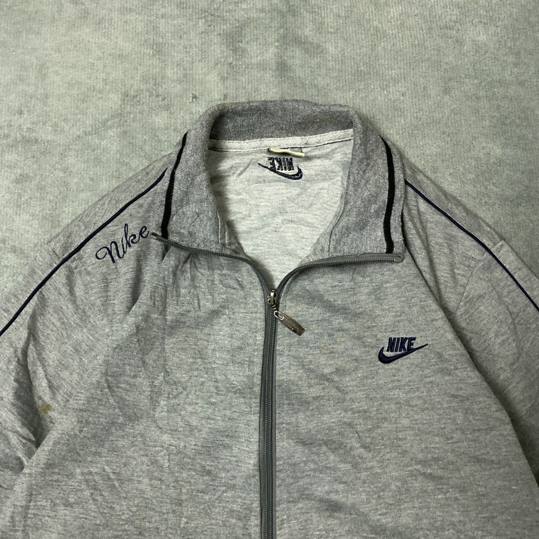 Nike Grey Track Jacket (Category: Hoodies) located in Imus. Submitted by lsthriftsaig (Listing ID 1462323848, Image 2). Description: Nike Grey Track Jacket Size tag: XL Length: 26 Width: 21.5 Issue(s): None Condition: 10/10.