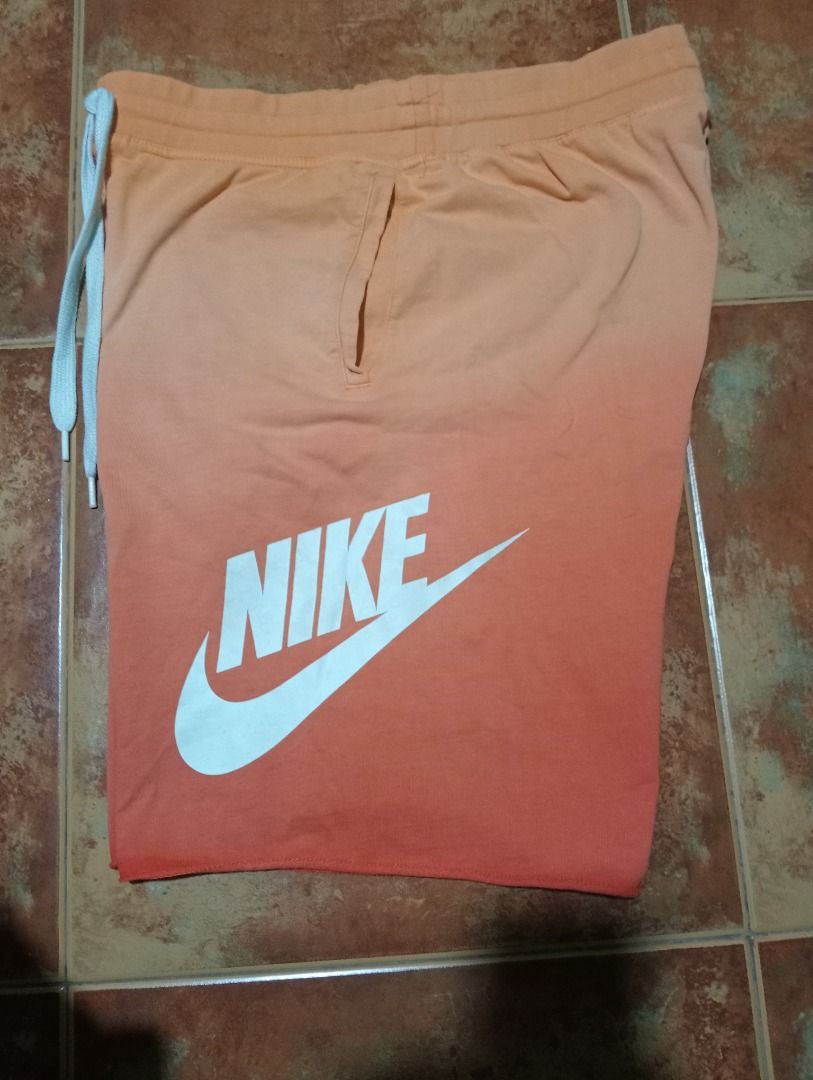 Nike Men's Orange Gradient Sweat Shorts XL (Category: Shorts) located in Caloocan City. Submitted by yazzielux (Listing ID 1462432869, Image 1). Description: - Orange Nike sweat shorts - Gradient color (light to dark orange) - White Nike logo - Elastic waistband with drawstring - Size: XL - Made in Vietnam - Ideal for lounging or casual wear.