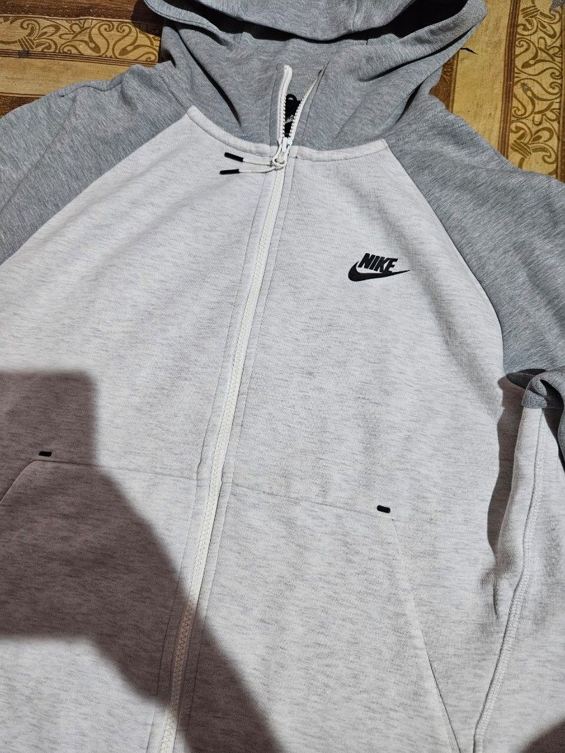 Nike Tech Fleece Full Zip Hoodie Grey (Category: Coats, Jackets and Outerwear) located in Las Pinas. Submitted by rcp123 (Listing ID 1462361896, Image 2). Description: - Nike Tech Fleece Hoodie - Color: Grey and Light Grey - Size: L - Features: Full zip closure, pockets, raglan sleeves - Condition: Minor snag on sleeve seam - Made in China.