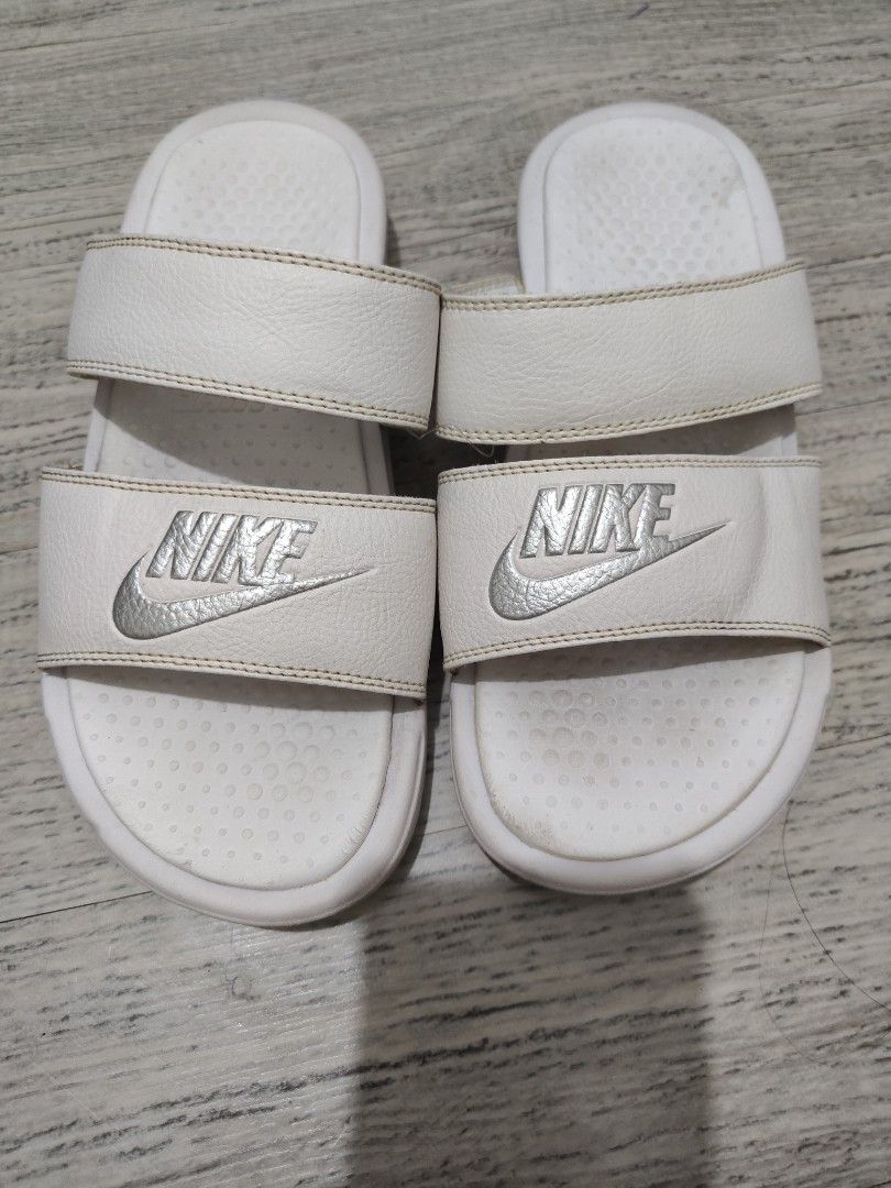 Nike White 2 Strap Slides Sandals - US6 (Category: Flats & Sandals) located in Calamba. Submitted by an_ne0501 (Listing ID 1462297178, Image 1). Description: - White Nike slides - Adjustable velcro straps - US6 / Size: 36.5 EUR / 23 CM - Minor signs of wear on straps and insoles - Ideal for casual wear.