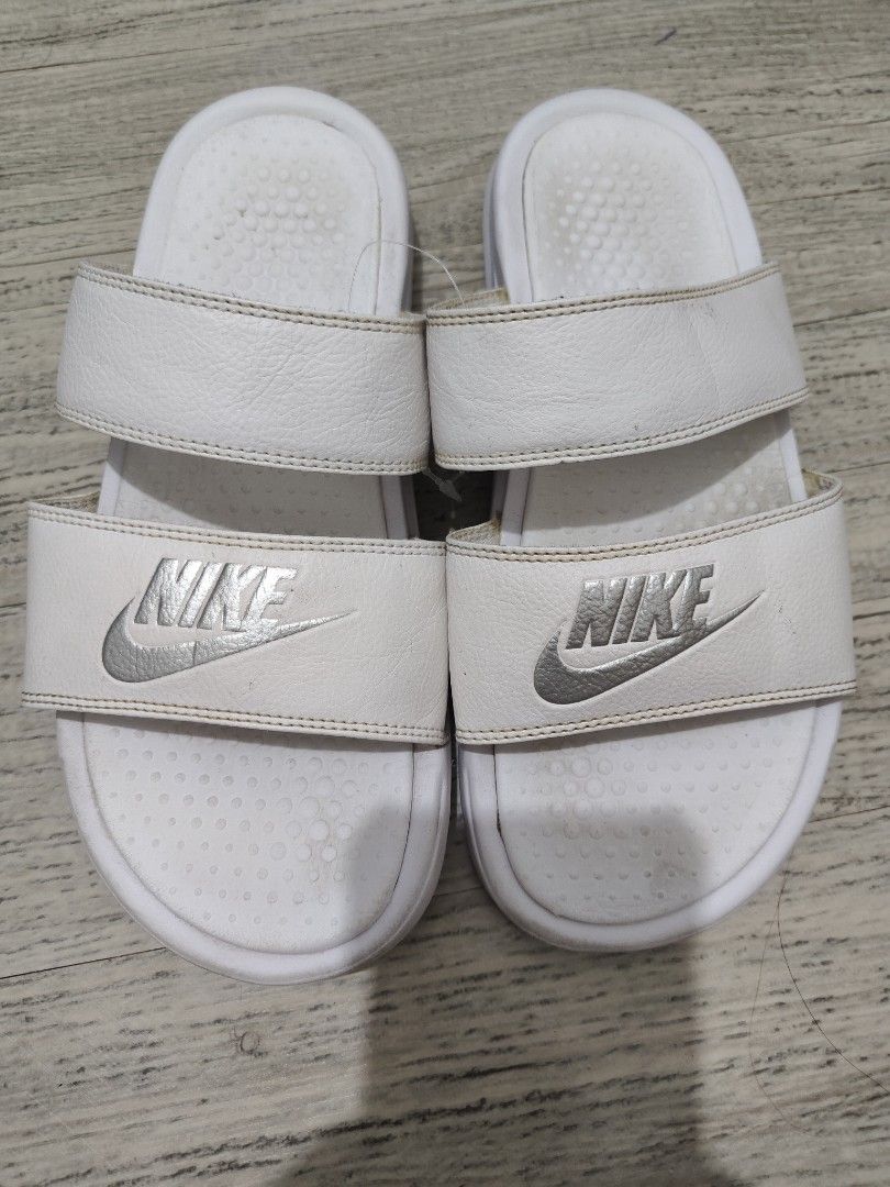 Nike White Dual Strap Slide Sandals - US7 (Category: Flats & Sandals) located in Calamba. Submitted by an_ne0501 (Listing ID 1462297530, Image 1). Description: - White Nike slide sandals - Dual strap design for a secure and comfortable fit - Perfect for casual outings or lounging - Size: US 7 / UK 4.5 / EUR 38 / CM 24 - Please note: Minor signs of wear on footbed and straps.