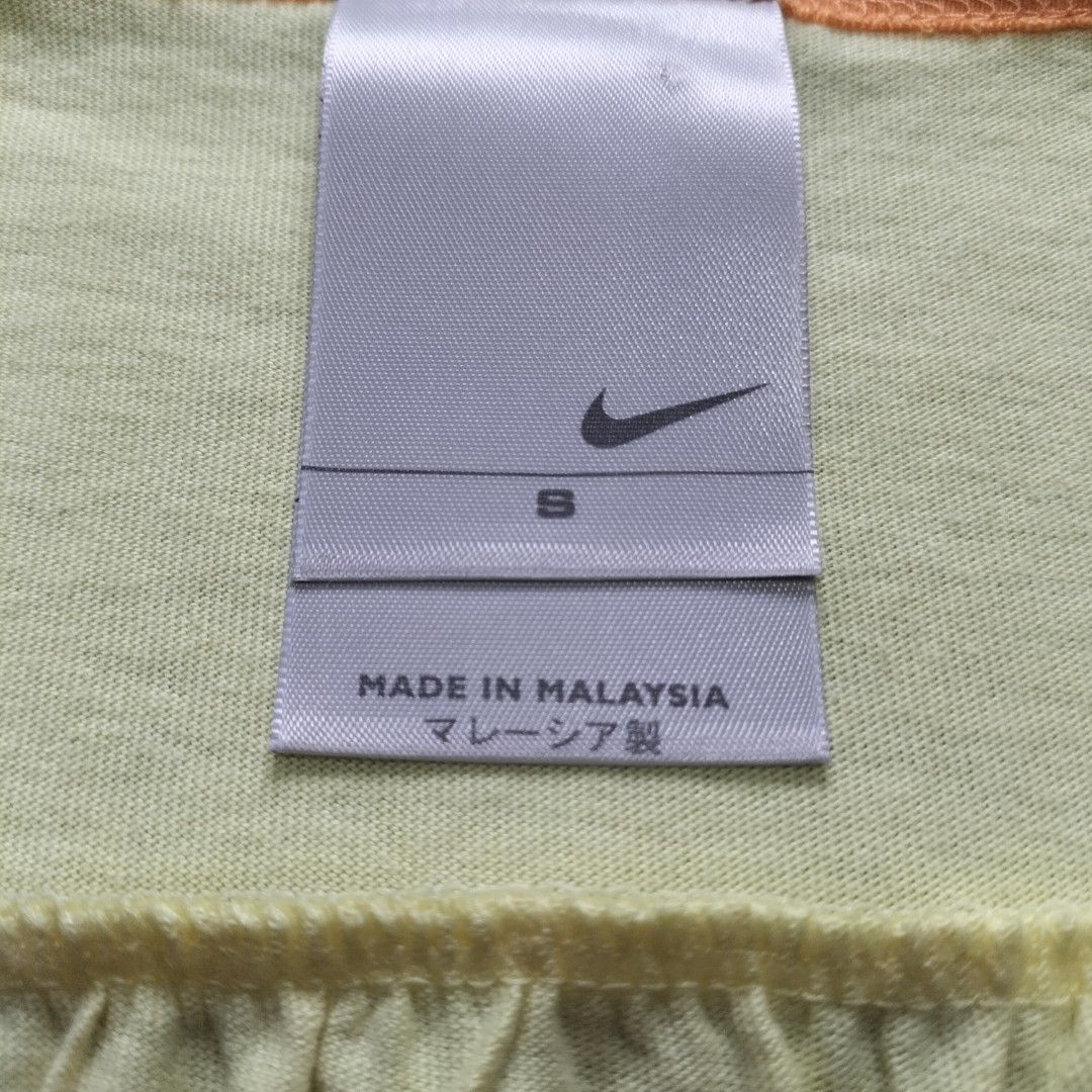 Nike Yellow Tank Top Size S (Category: Sleeveless) located in Taytay. Submitted by calmtree-6248 (Listing ID 1462364294, Image 2). Description: - Yellow Nike tank top with orange trim - Front graphic print: 'NIKE' text and tropical scene - Small Nike logo on the back - Material: 100% Cotton - Care: Machine washable cold - Size: S - Ideal for casual wear or workouts.