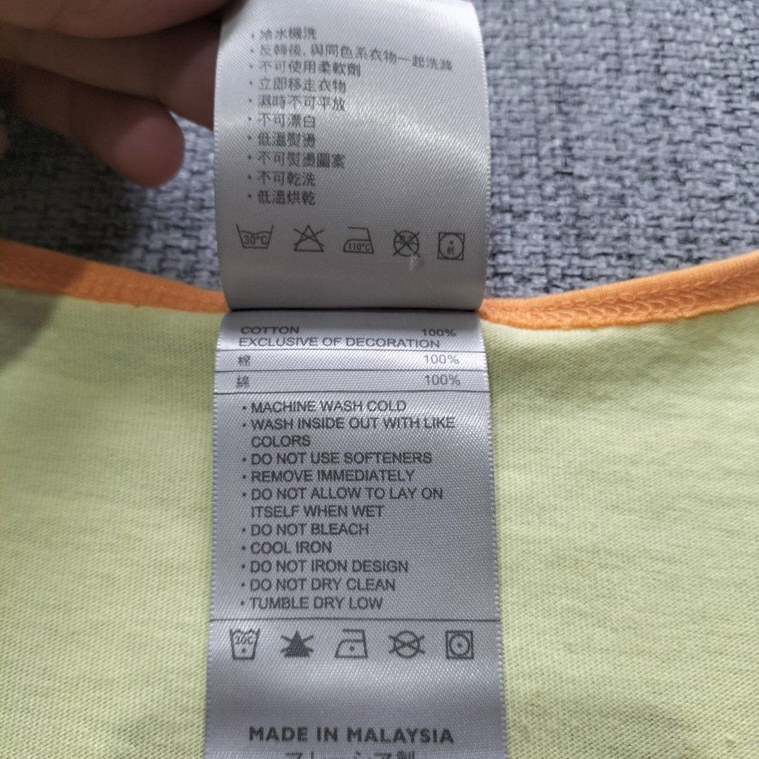 Nike Yellow Tank Top Size S (Category: Sleeveless) located in Taytay. Submitted by calmtree-6248 (Listing ID 1462364294, Image 3). Description: - Yellow Nike tank top with orange trim - Front graphic print: 'NIKE' text and tropical scene - Small Nike logo on the back - Material: 100% Cotton - Care: Machine washable cold - Size: S - Ideal for casual wear or workouts.