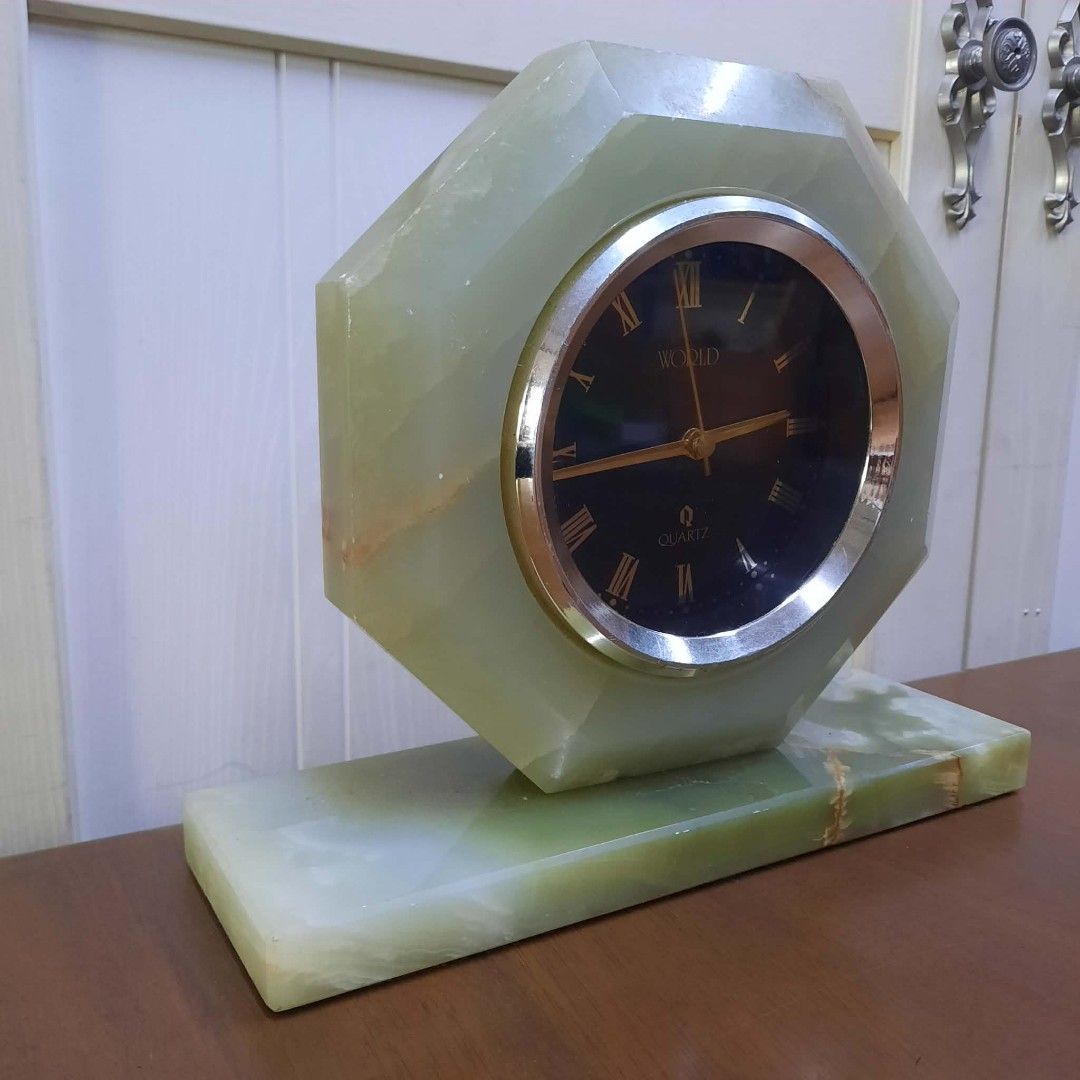 Octagonal Onyx Quartz Desk Clock (Category: Clocks) located in Manila. Submitted by ivan_furnitures421 (Listing ID 1462278042, Image 2). Description: - Octagonal desk clock crafted from luxurious green onyx. - Features a classic black face with Roman numerals. - Elegant gold-tone hands. - Set on a sturdy, matching onyx base. - Reliable quartz movement for accurate timekeeping. - A sophisticated decorative piece for desks, shelves, or mantels..