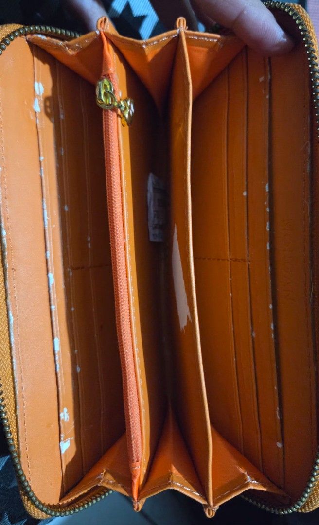 Morgan Orange Zip Around Long Wallet (Category: Wallets & Card holders) located in Quezon City. Submitted by kctheexplorer05 (Listing ID 1462330271, Image 3). Description: - Vibrant orange zip-around wallet - Ample interior compartments for cards and cash - Shows some signs of wear (exterior marks, but overall okay only interior scuffs as seen in photo) - Zipper operates smoothly - Perfect for everyday organization and use -WYIWYG .