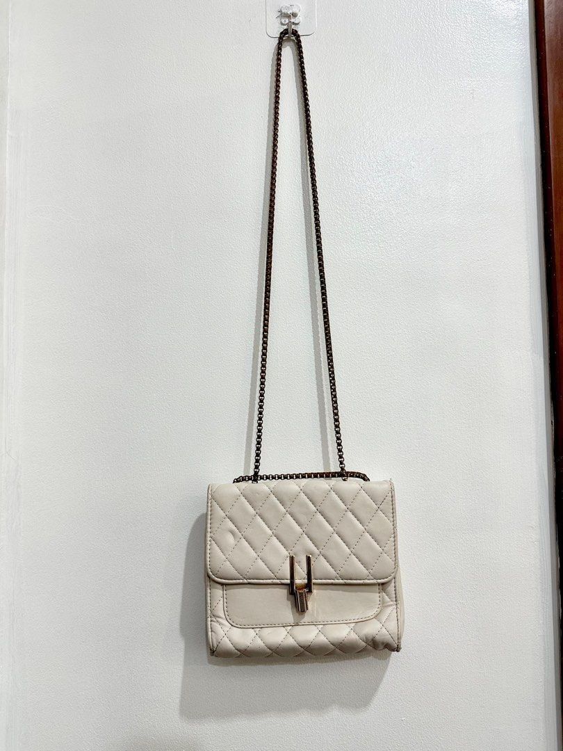 Pale Pink Quilted Chain Shoulder Bag (Category: Shoulder Bags) located in Quezon City. Submitted by decluttering_alot (Listing ID 1462311072, Image 1). Description: - Pale pink quilted shoulder bag - Gold chain strap - Flap closure with metal clasp - Interior zippered compartment - Small and compact size - Versatile for nights out or casual wear RFS: closet cleanup, never used.