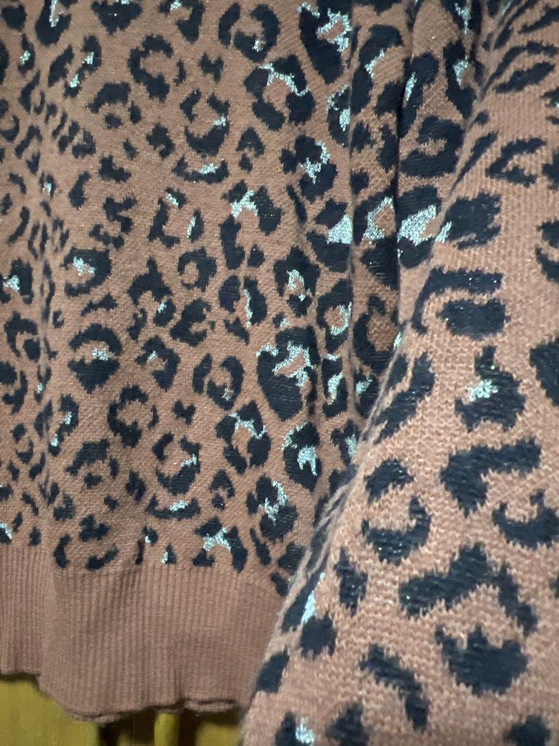 Pasoro Leopard Print V-Neck Knit Sweater (Category: Coats, Jackets and Outerwear) located in Pasig City. Submitted by zebteashoppe01 (Listing ID 1462410541, Image 2). Description: - Cozy brown knit sweater - Classic leopard print with black, white, and light blue accents - V-neckline - Ribbed cuffs and hem - Versatile for layering or wearing on its own - Stylish and comfortable Small .